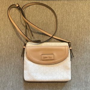 Calvin Klein. White and cream. Long shoulder strap that is adjustable.